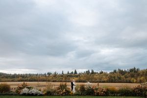 A panoramic view of rolling farmland with cloudy skies stretches across multiple connected landscape photographs.