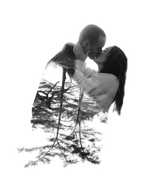 A double exposure black and white photograph shows a person's silhouette merged with forest trees.