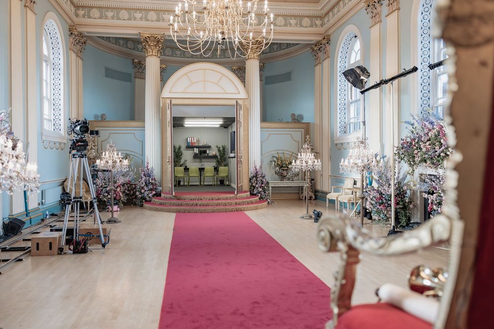 Behind the scenes of a Bridgerton Netflix filming setup at Newark Town Hall, showing the media setup of the ballroom.