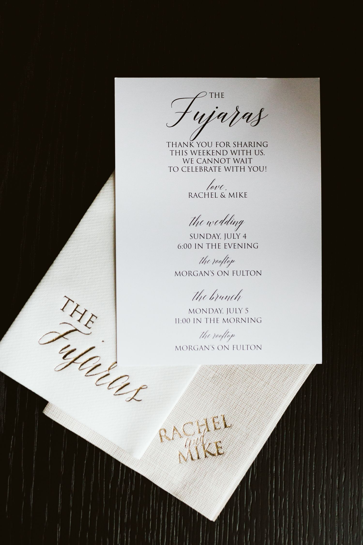 Elegant wedding itinerary cards with calligraphy details printed in black and gold.