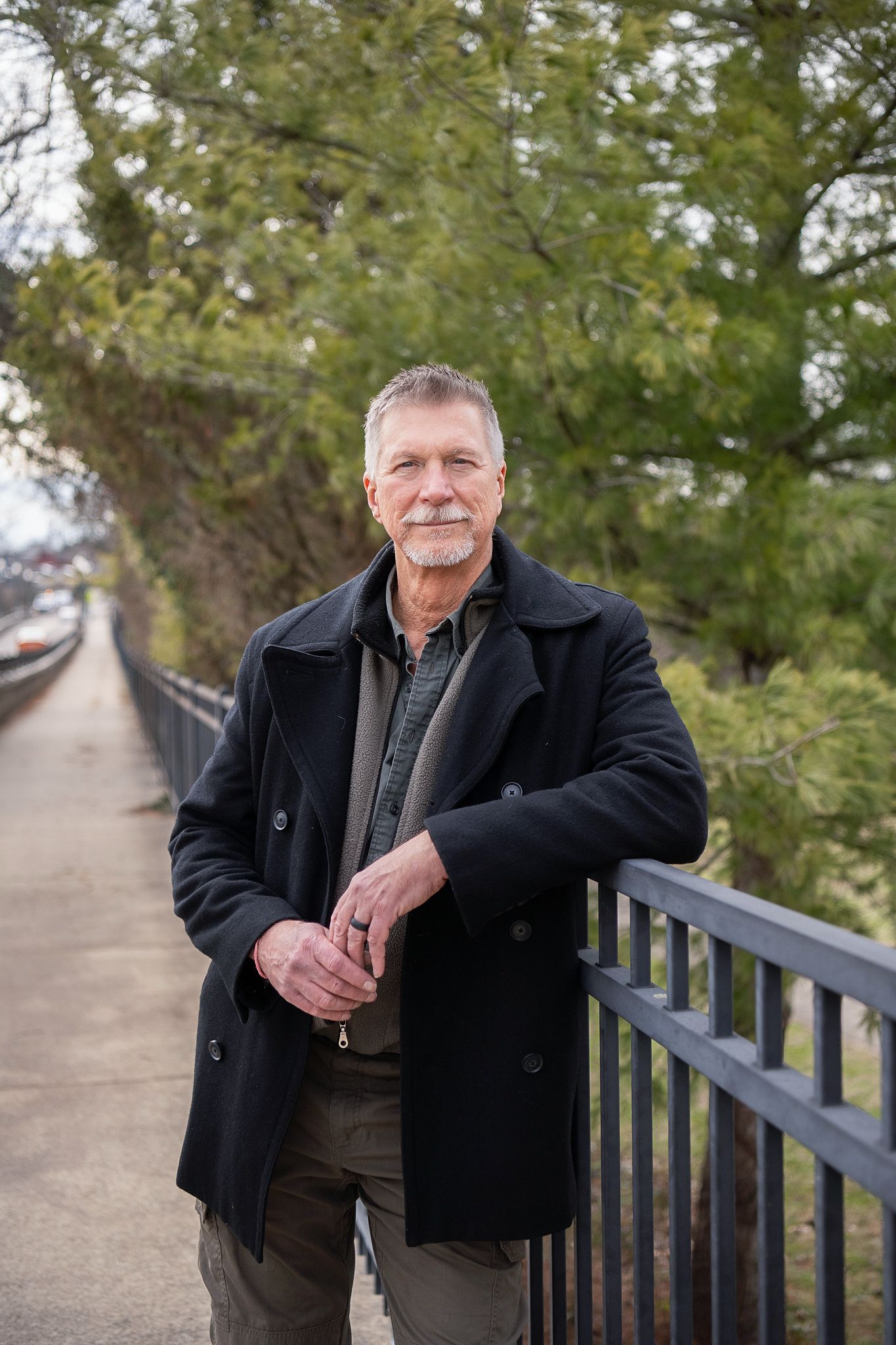 A series of headshots showing someone with a gray mustache wearing a black fleece jacket against a blurred outdoor background.