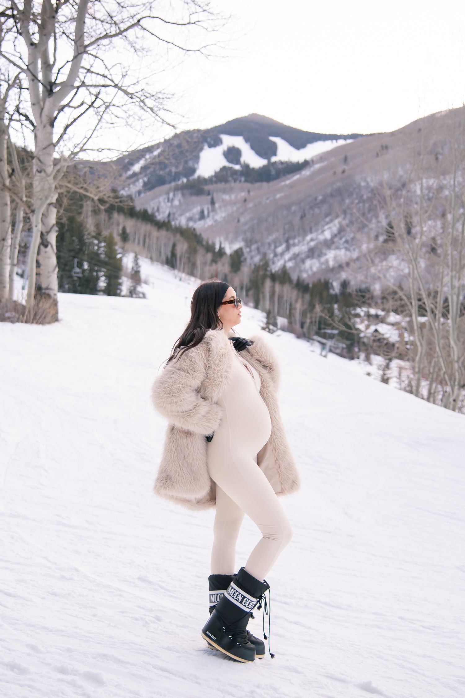 Fashion winter maternity photo session in the snowy mountains in Vail Colorado