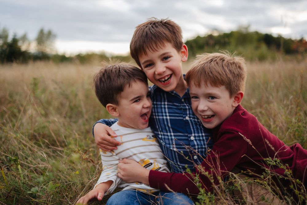 Candid moments of playful interaction in an autumn field.