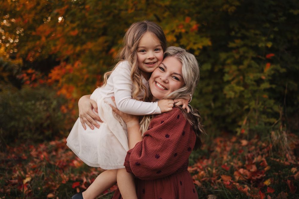 Warm autumn scene with embraces among fall foliage and golden light.