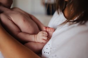 Close-up shot of hands touching tenderly against a soft blurred background.