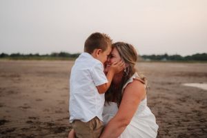 Romantic moment shared between couple on sandy beach at sunset.