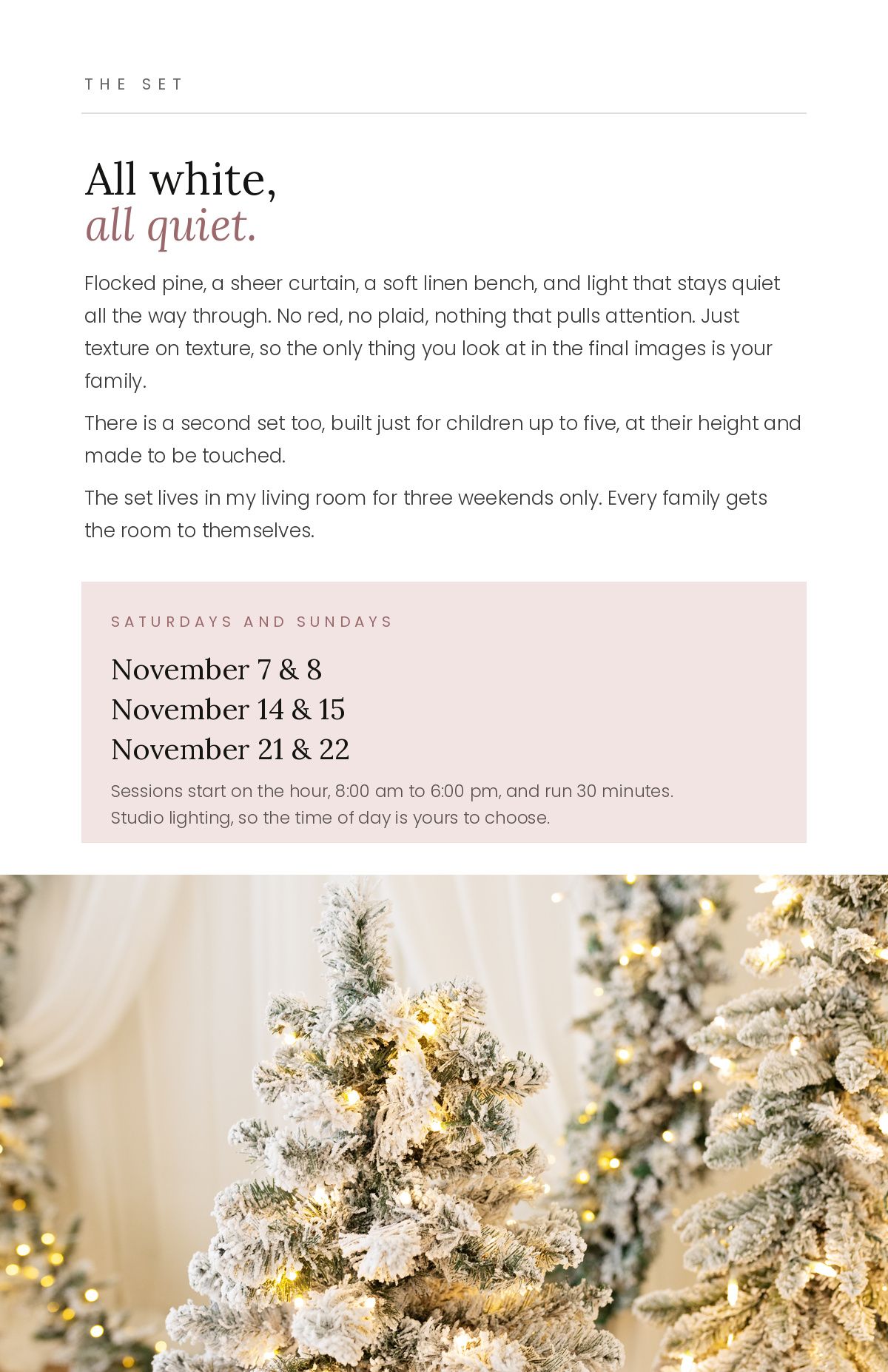 White flocked Christmas trees with soft lighting on an all-white photography set with linen bench and sheer curtains.