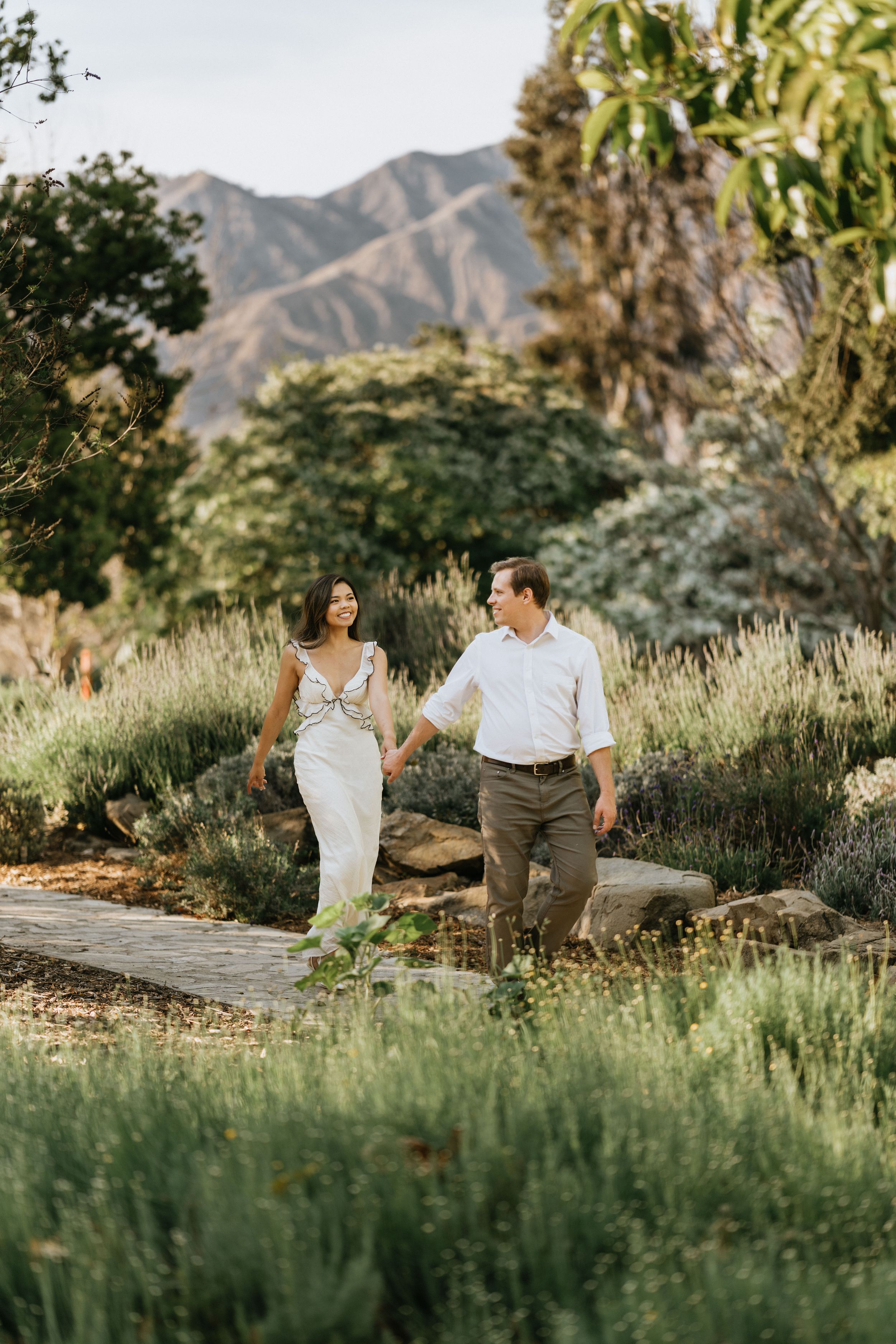 Mariel and Jeff walking together with the San Gabriel Mountains behind them.