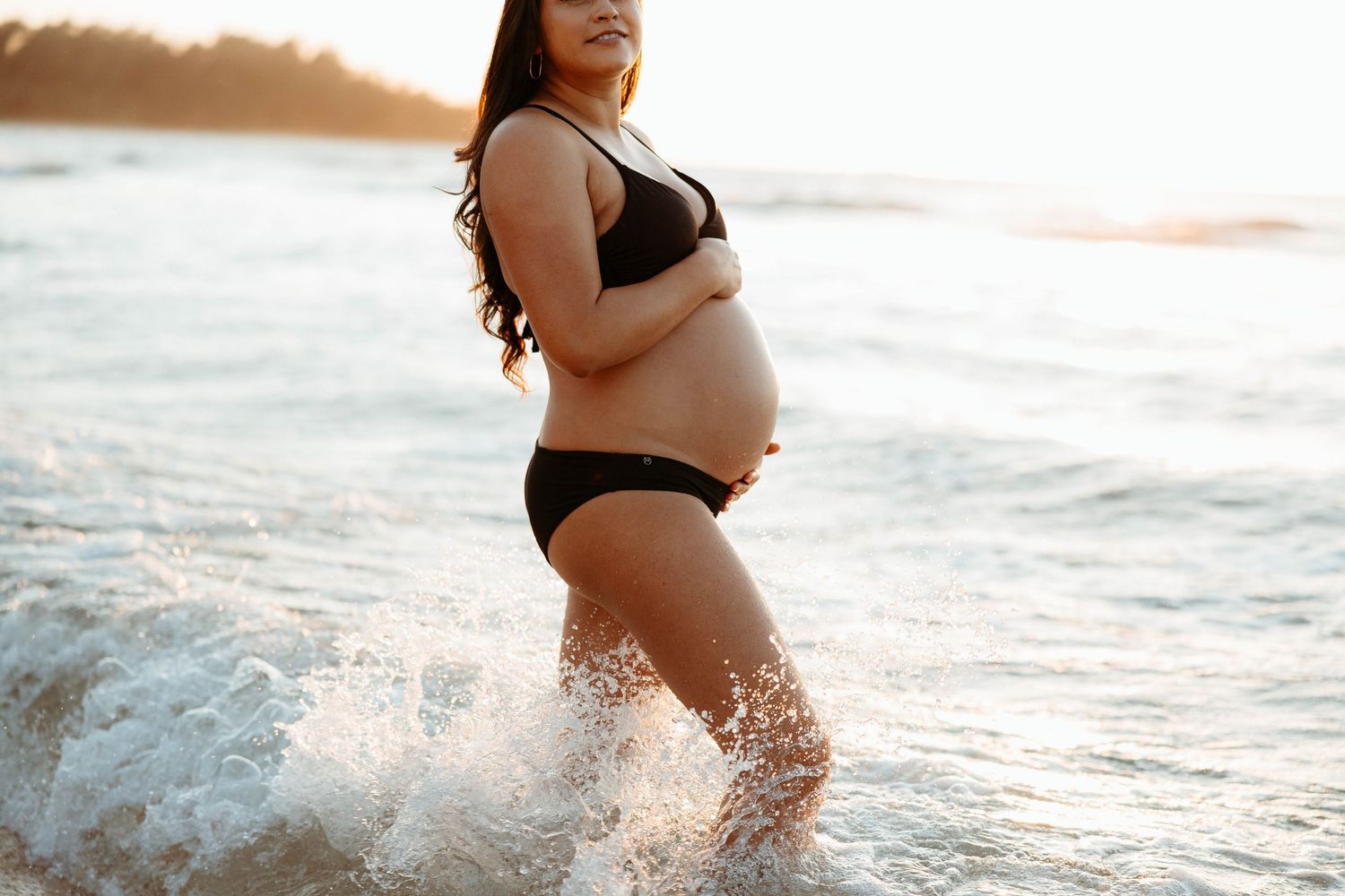 Outdoor maternity portraits capturing the beauty of pregnancy at Tunnels Beach, Kauai.