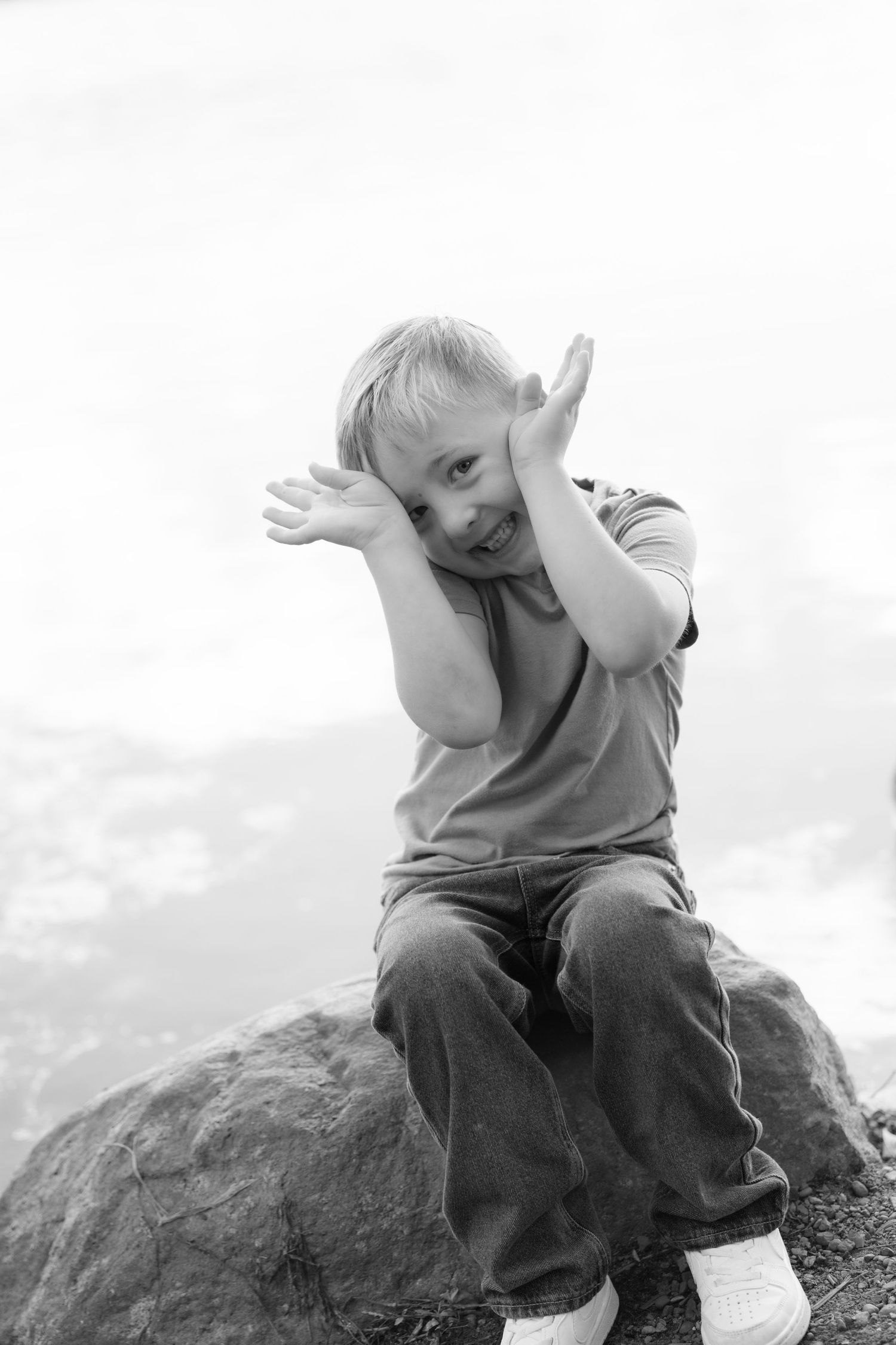 black and white silly headshot of grandchild during  extended family portrait session at powers lake park in woodbury mn