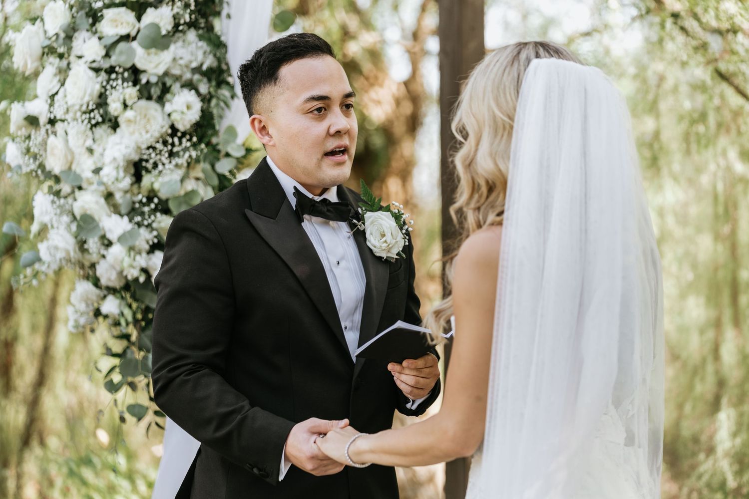 Paul speaking to Gabriella during their outdoor wedding ceremony