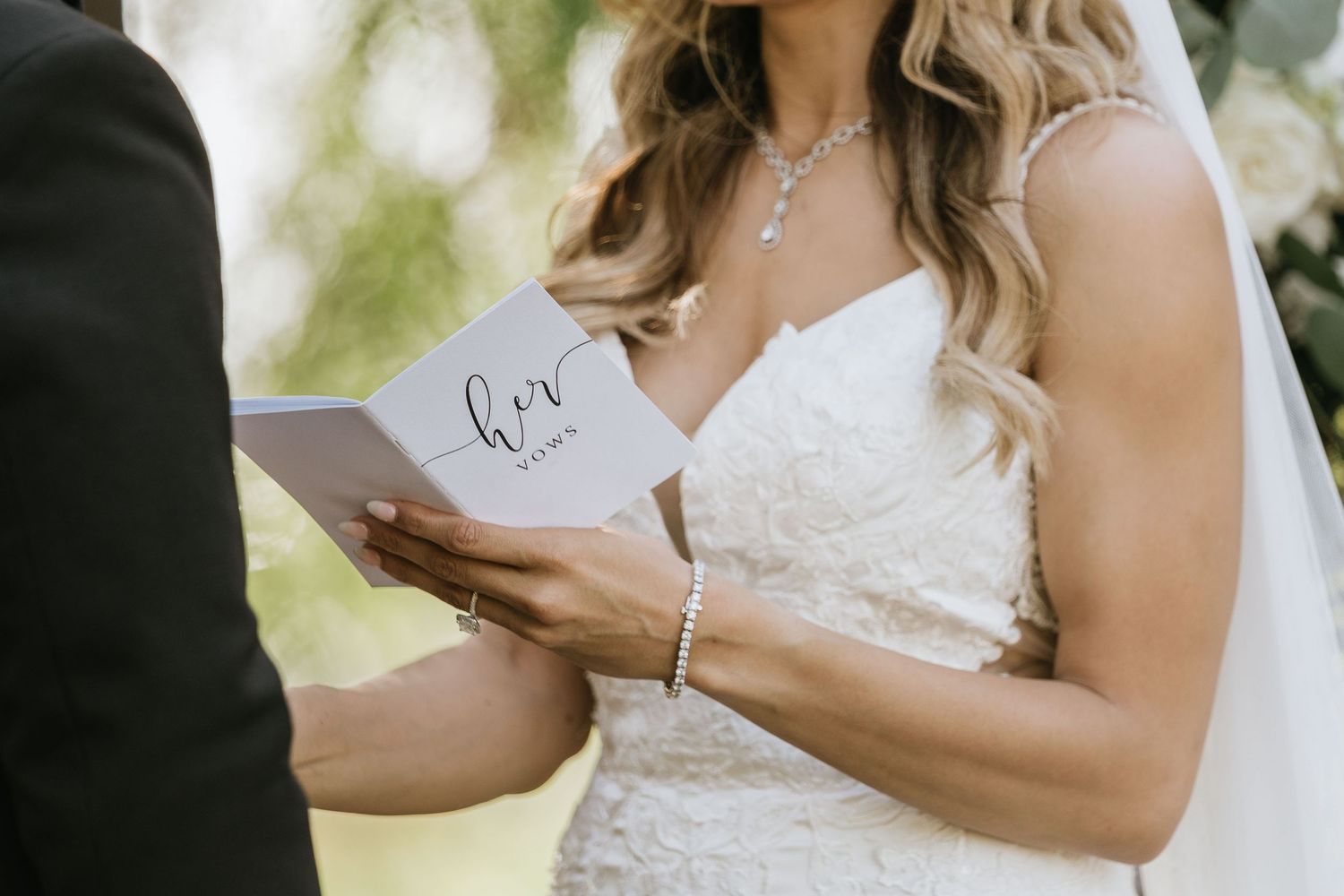 Gabriella reading her vows from a handwritten vow book