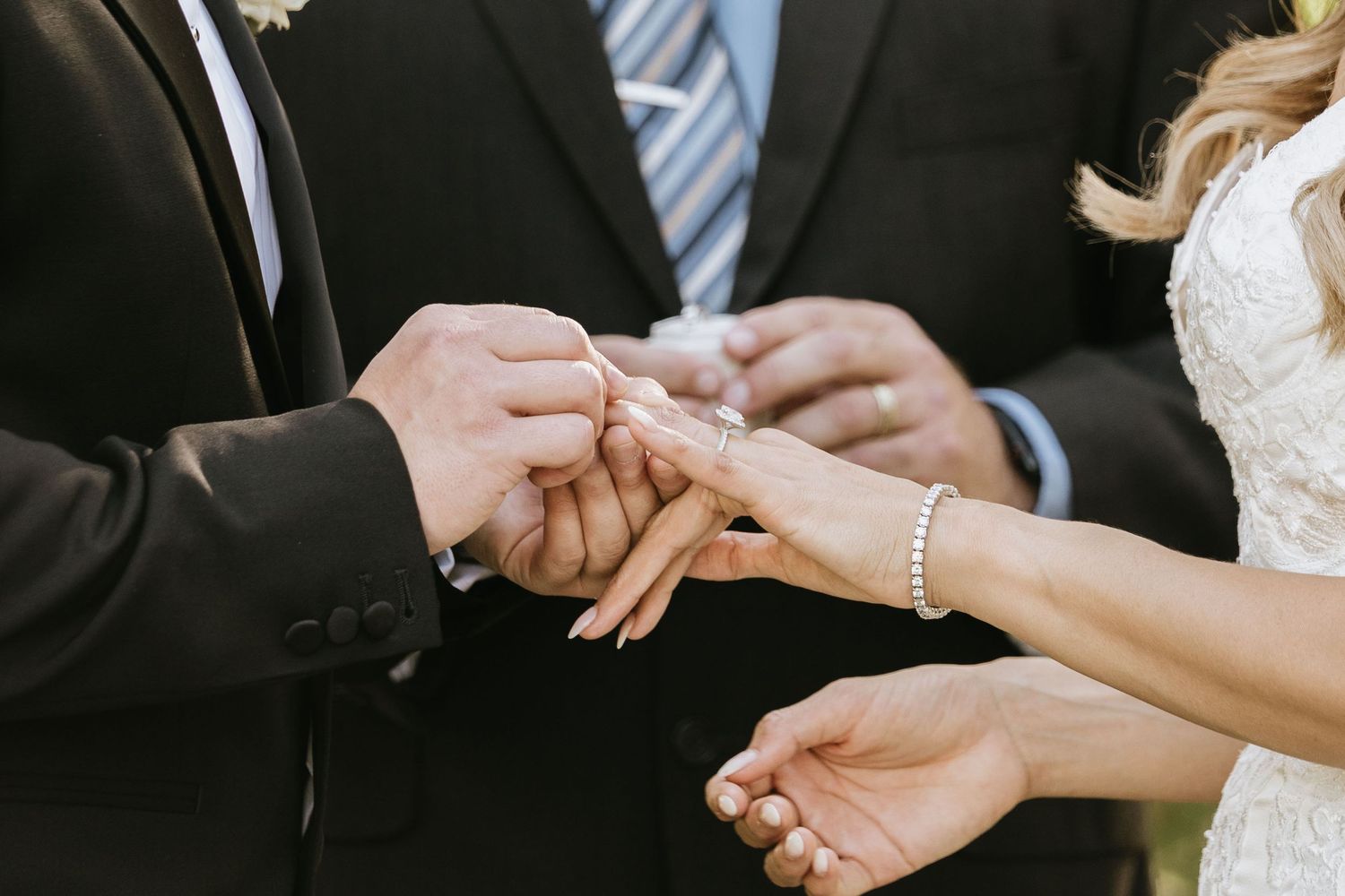 Gabriella placing Paul’s wedding ring on his finger