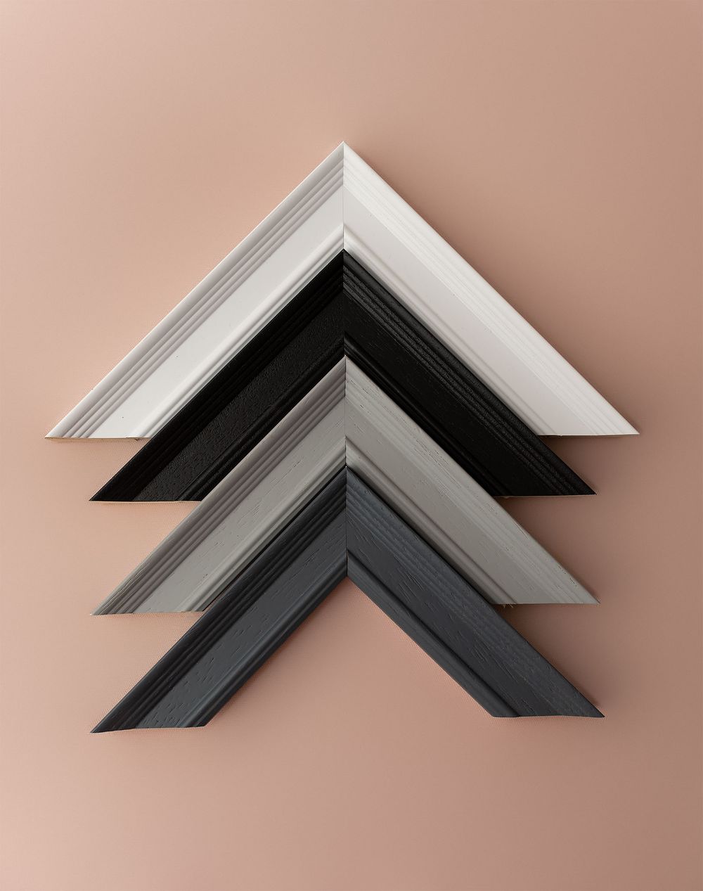 Four picture frame corner samples in white, black, and gray tones arranged in a chevron pattern available at Ada Studio Oban