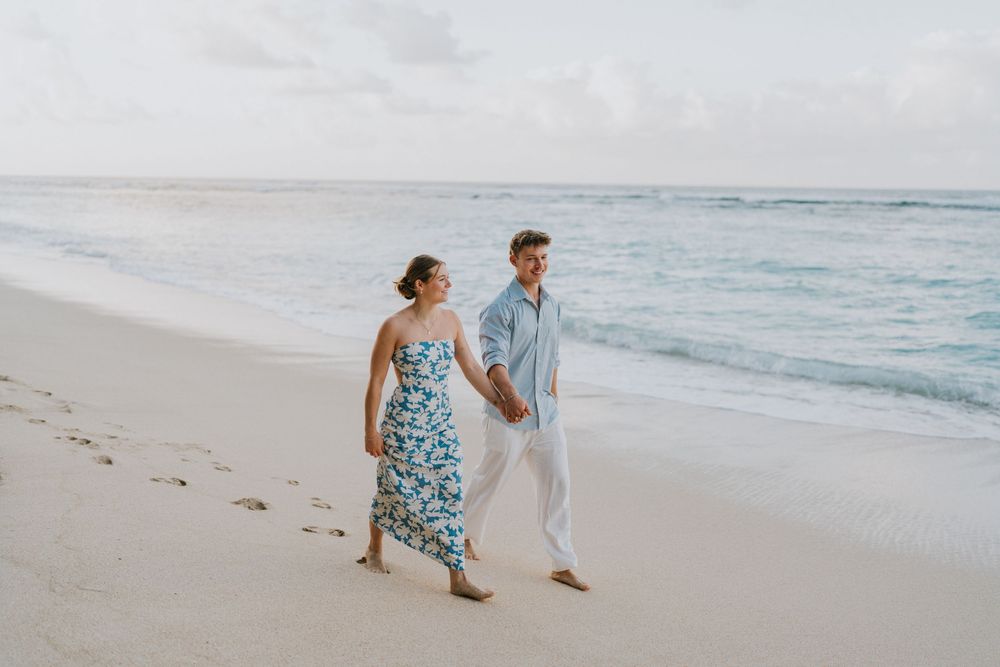Romantic surprise proposal at Melasti Beach Bali during golden hour.