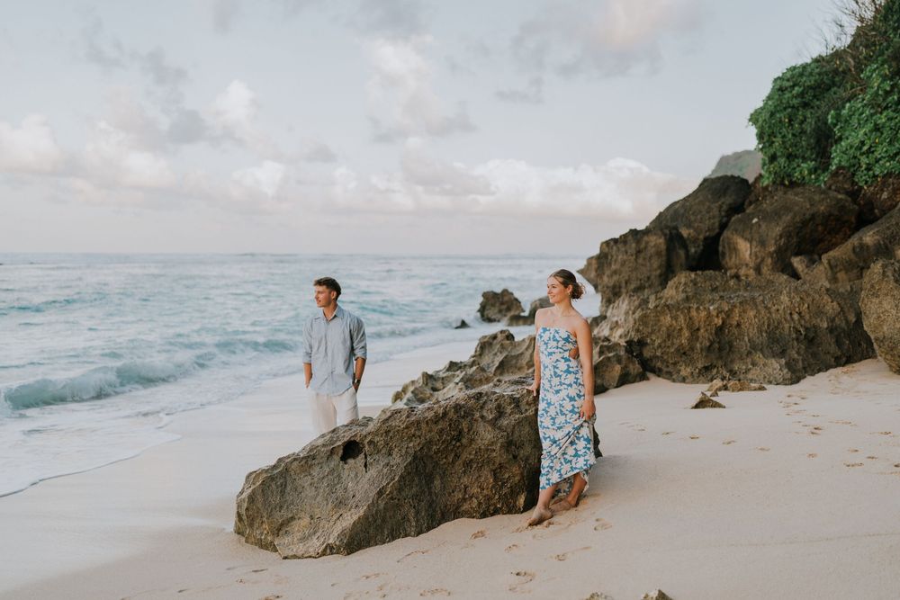 Romantic surprise proposal at Melasti Beach Bali during golden hour.