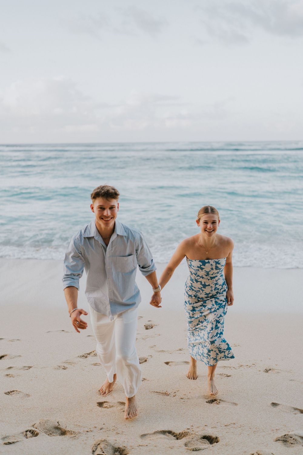 Romantic surprise proposal at Melasti Beach Bali during golden hour.