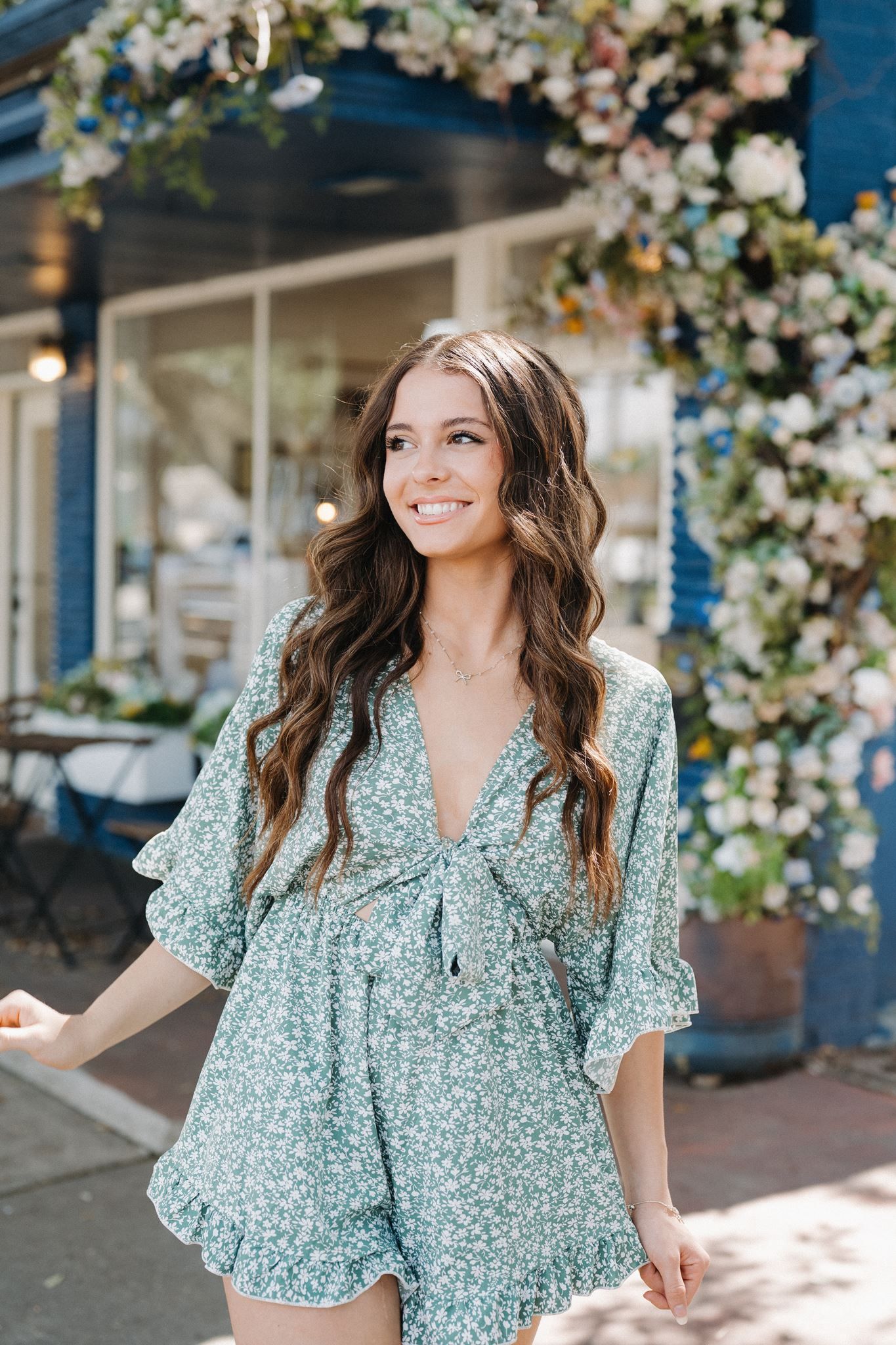 Tomball High School senior girl posing in front of a bake shop in Tomball Texas.