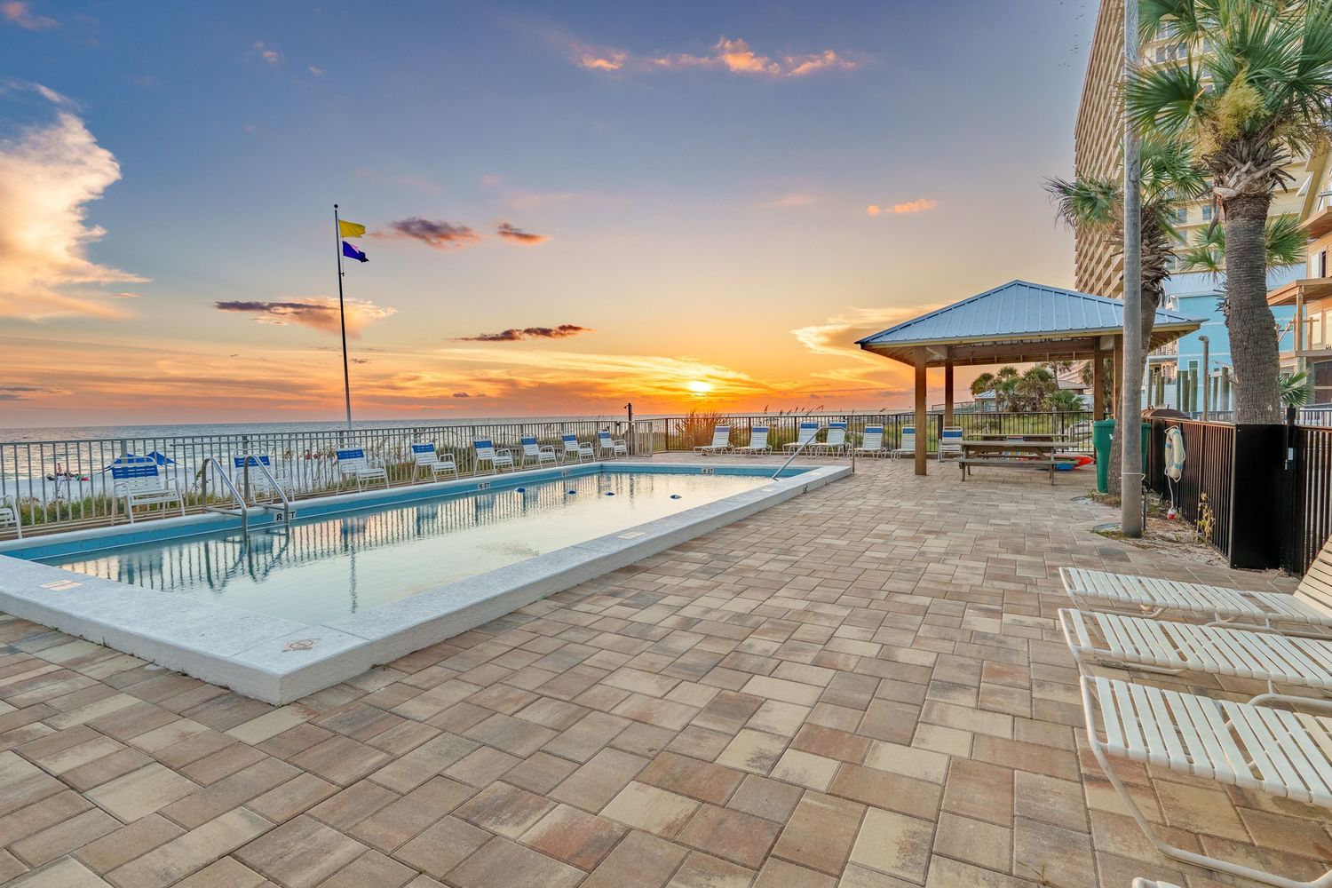 Twilight real estate photography of a beachfront pool and sunset in Panama City Beach