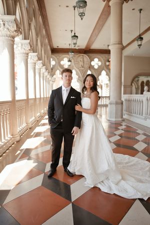 Bride and groom posing in elegant marble corridor with ornate columns at The Venetian Las Vegas wedding.
