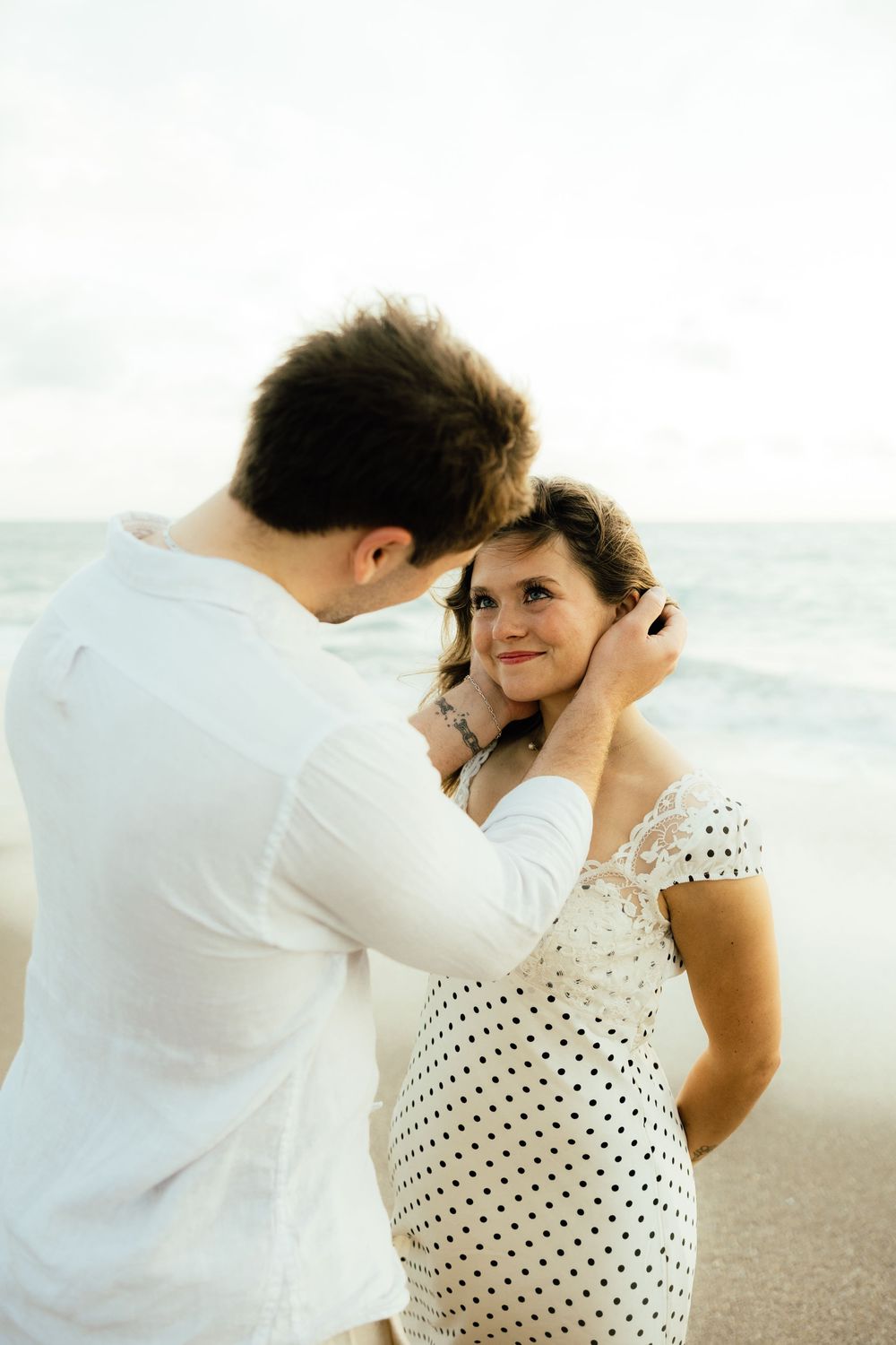 Playful sunrise beach engagement photos with golden light and bright blue waters. Jacksonville Engagement Photographer - Lindsay McDow Photo