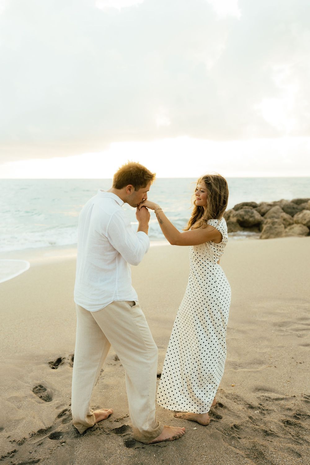 Playful sunrise beach engagement photos with golden light and bright blue waters. Jacksonville Engagement Photographer - Lindsay McDow Photo
