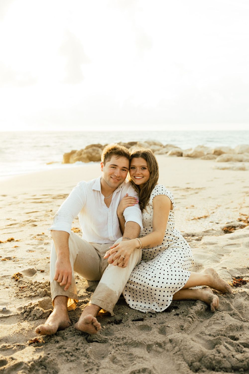Playful sunrise beach engagement photos with golden light and bright blue waters. Jacksonville Engagement Photographer - Lindsay McDow Photo