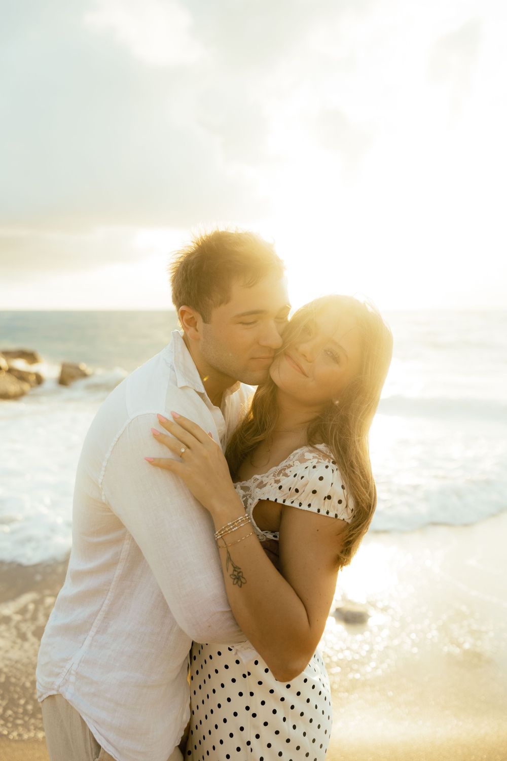 Playful sunrise beach engagement photos with golden light and bright blue waters. Jacksonville Engagement Photographer - Lindsay McDow Photo