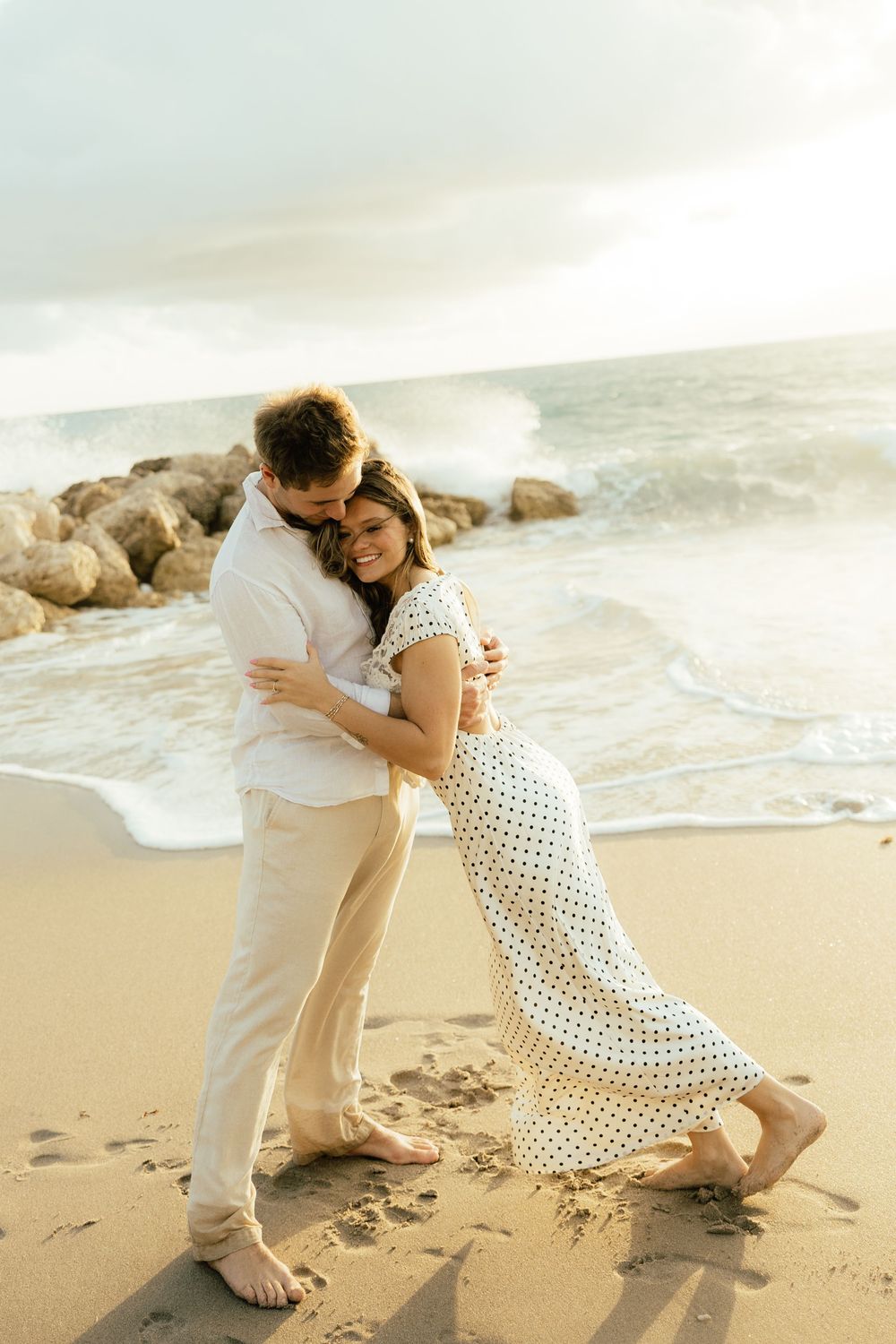 Playful sunrise beach engagement photos with golden light and bright blue waters. Jacksonville Engagement Photographer - Lindsay McDow Photo