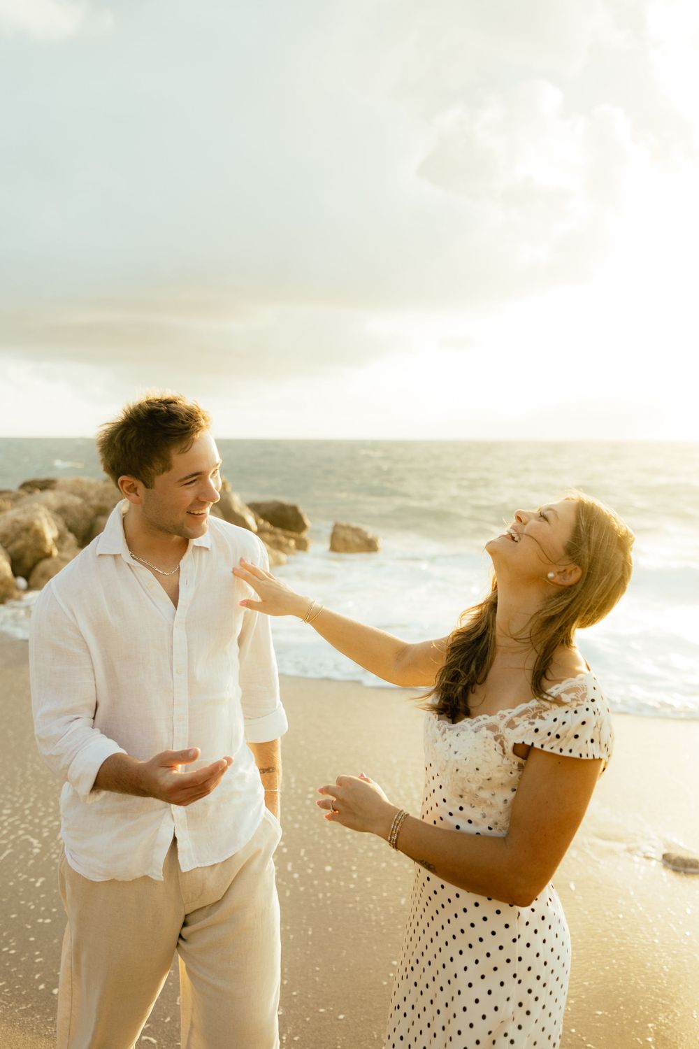 Playful sunrise beach engagement photos with golden light and bright blue waters. Jacksonville Engagement Photographer - Lindsay McDow Photo