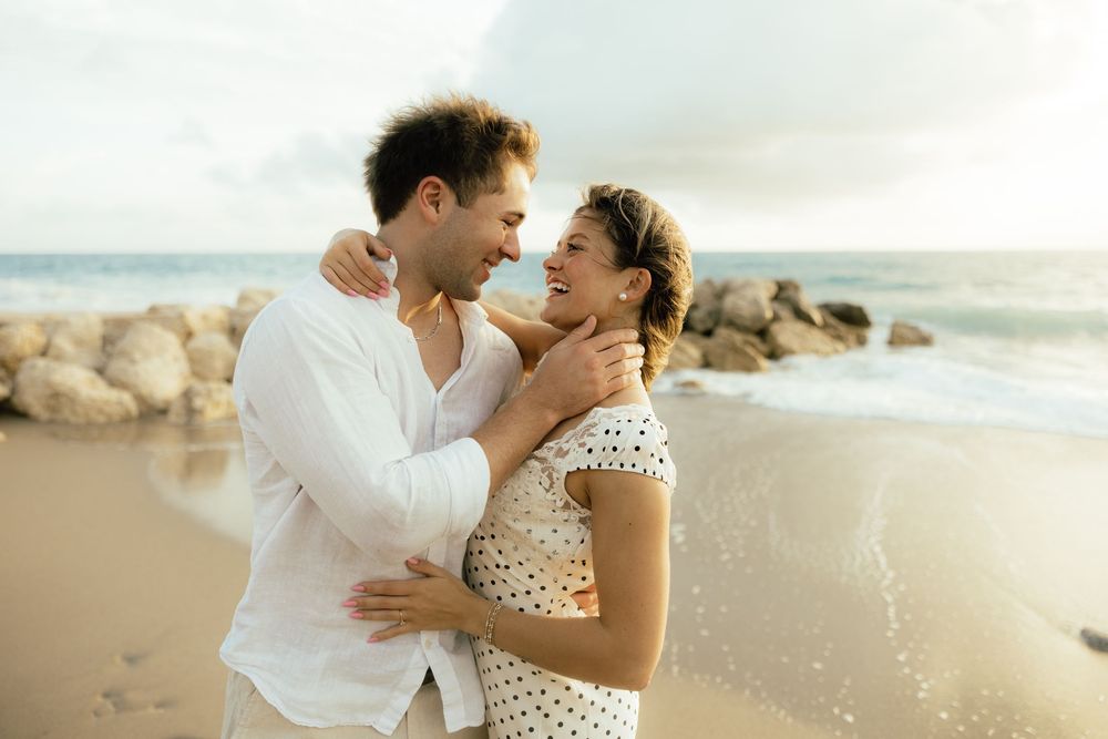 Playful sunrise beach engagement photos with golden light and bright blue waters. Jacksonville Engagement Photographer - Lindsay McDow Photo