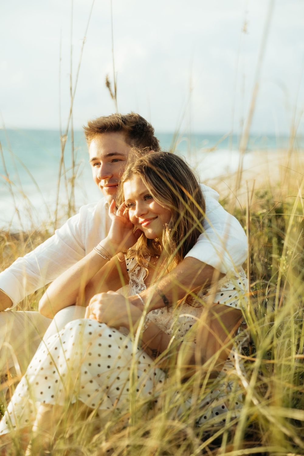 Playful sunrise beach engagement photos with golden light and bright blue waters. Jacksonville Engagement Photographer - Lindsay McDow Photo