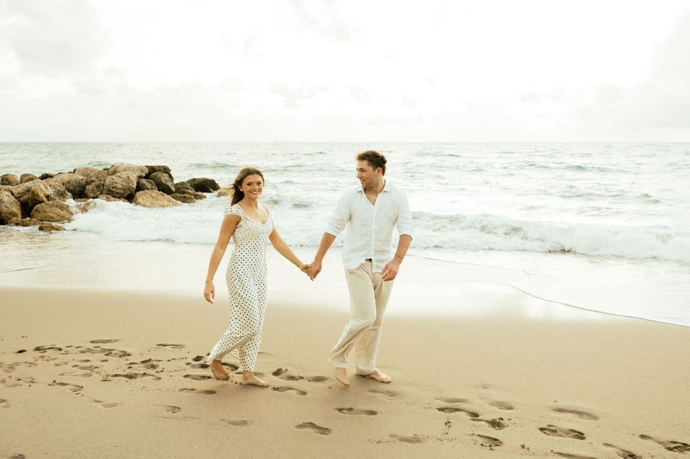 Playful sunrise beach engagement photos with golden light and bright blue waters. Jacksonville Engagement Photographer - Lindsay McDow Photo