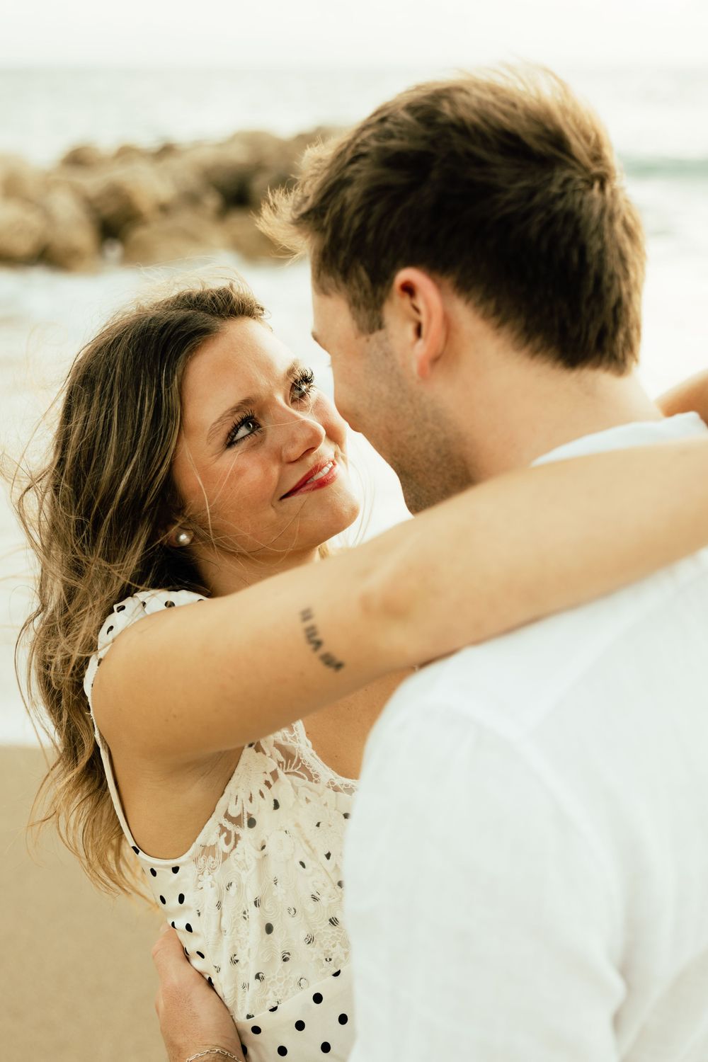 Playful sunrise beach engagement photos with golden light and bright blue waters. Jacksonville Engagement Photographer - Lindsay McDow Photo