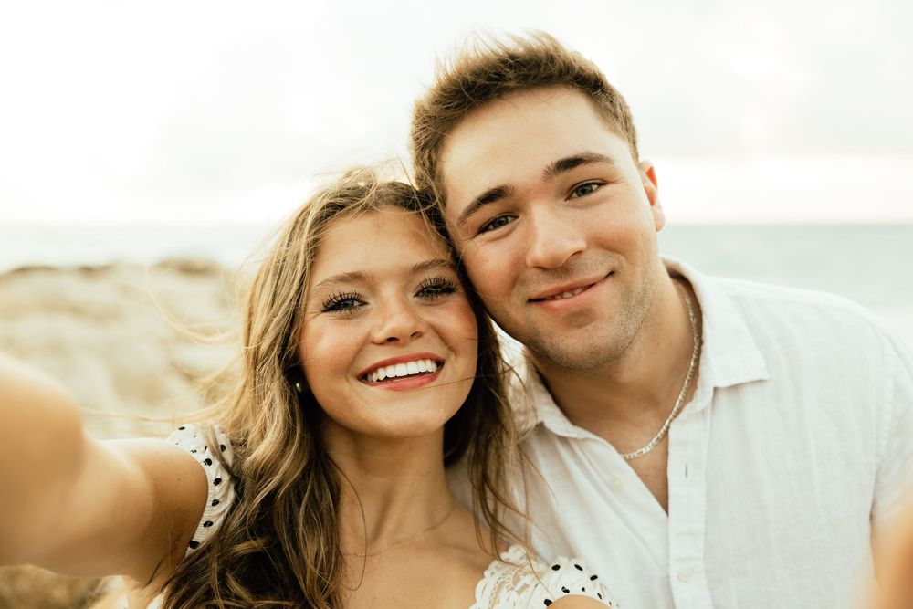 Playful sunrise beach engagement photos with golden light and bright blue waters. Jacksonville Engagement Photographer - Lindsay McDow Photo