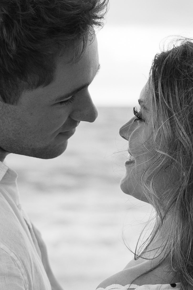 Playful sunrise beach engagement photos with golden light and bright blue waters. Jacksonville Engagement Photographer - Lindsay McDow Photo