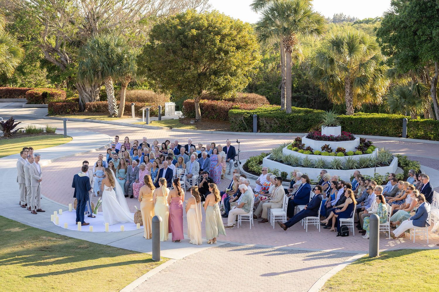 Wedding ceremony in the circle driveway at the Mansion at Tuckahoe with guests seated around the planter