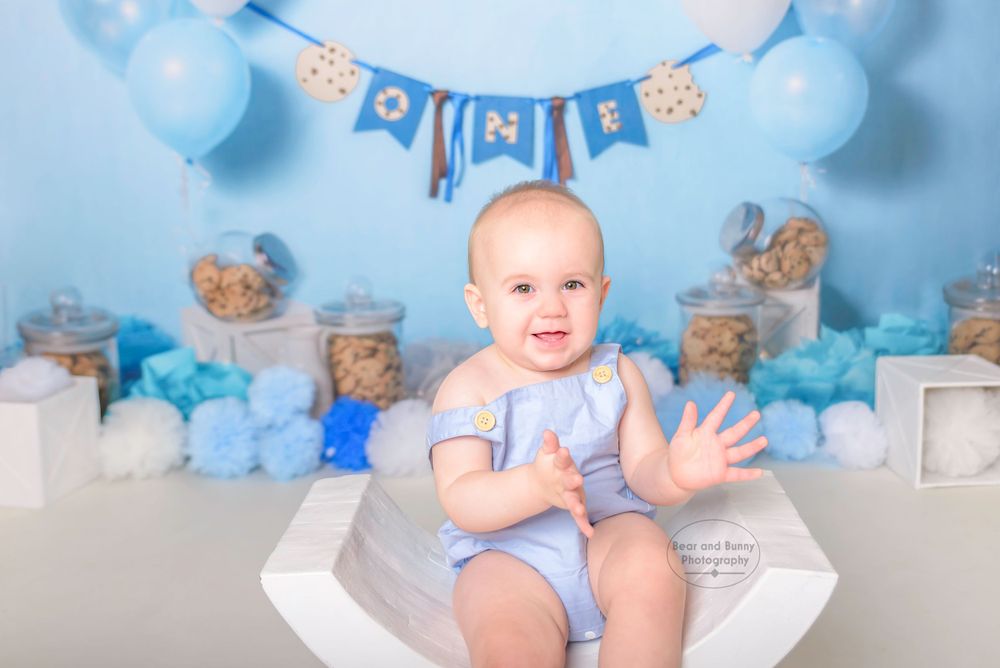 Little boy clapping hands at his Cake Smash Photoshoot