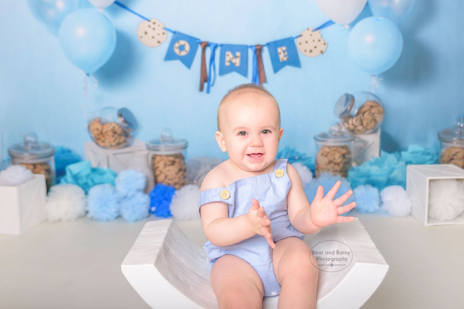 Little boy clapping hands at his Cake Smash Photoshoot