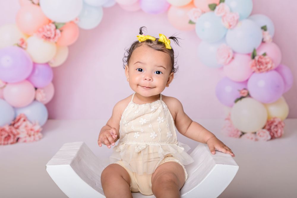 Little girl sat in curved chair at photoshoot