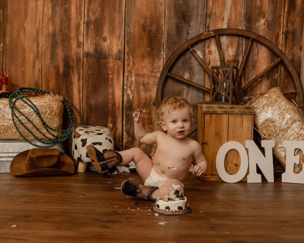 Warm-toned vintage nursery setup against wooden wall with stuffed animals and rustic decorative elements.