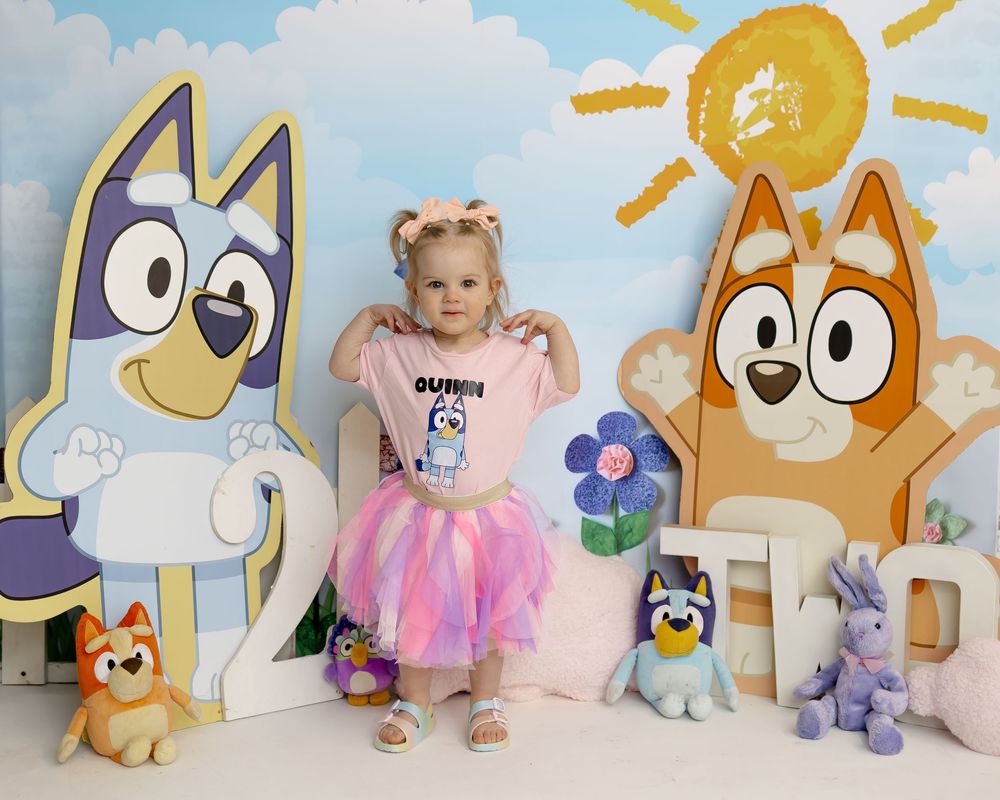 Animated cartoon backgrounds with animal plush toys and pastel decorations arranged for a photo session.