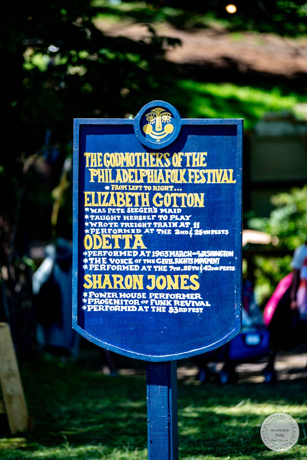 Blue historical marker sign honoring the Godmothers of the Philadelphia Folk Festival including Elizabeth Cotton, Odetta, and Sharon Jones.