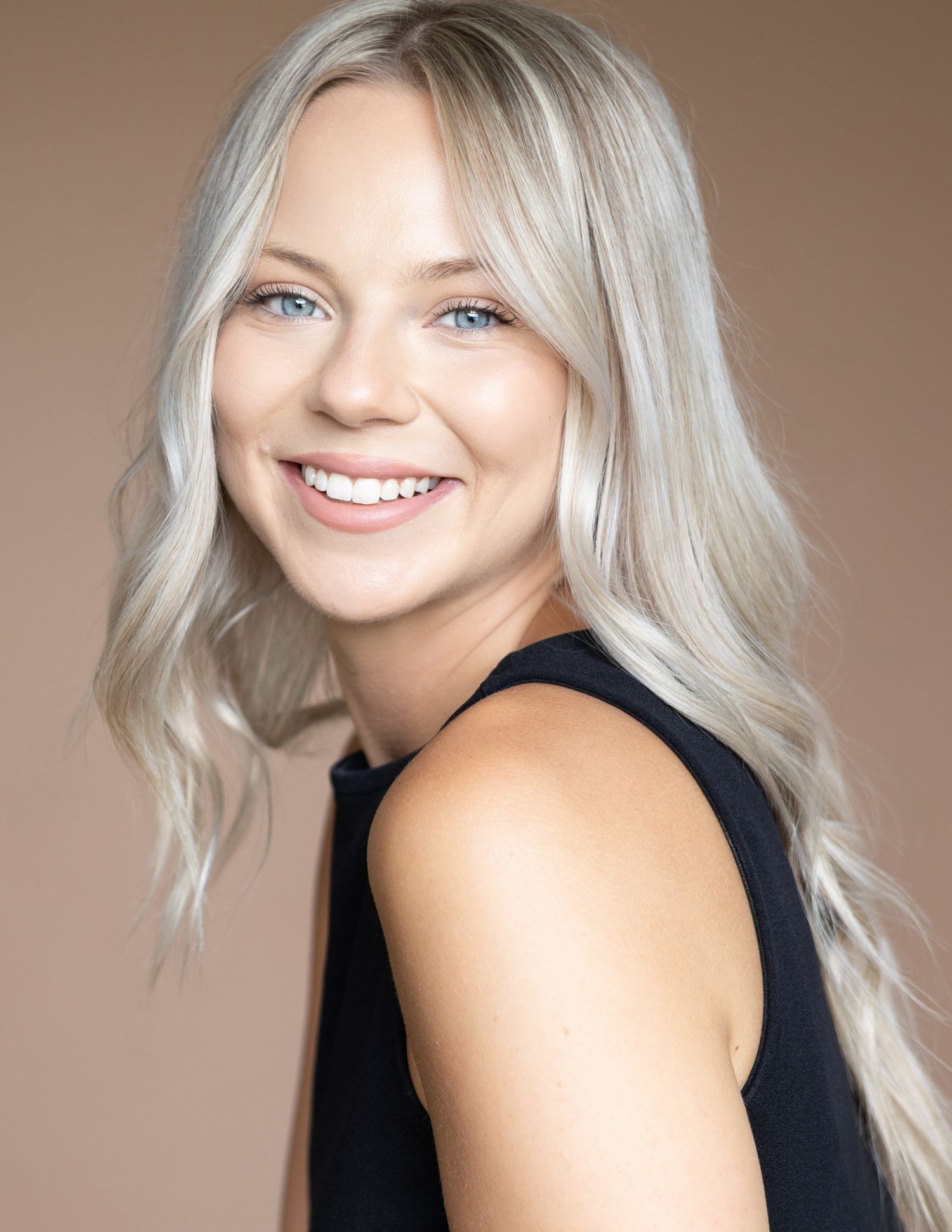 Model headshot on warm neutral backdrop for portfolio update