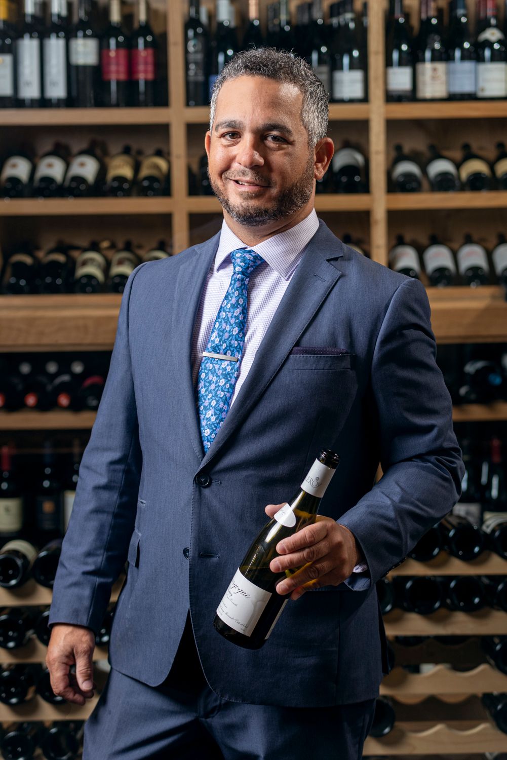 Sommelier holding a bottle of wine in Houston, TX.