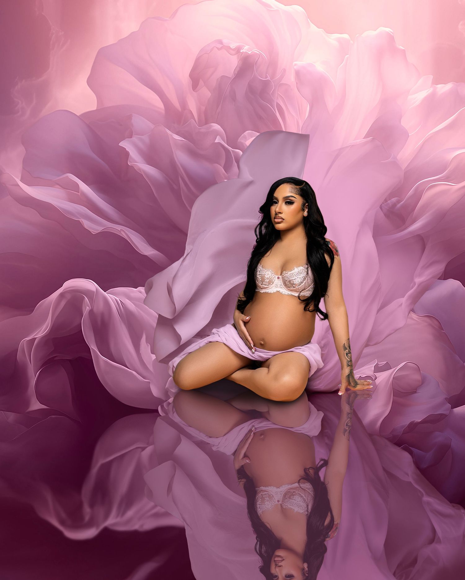 Maternity photo with white lingerie against pink rose petal background.
