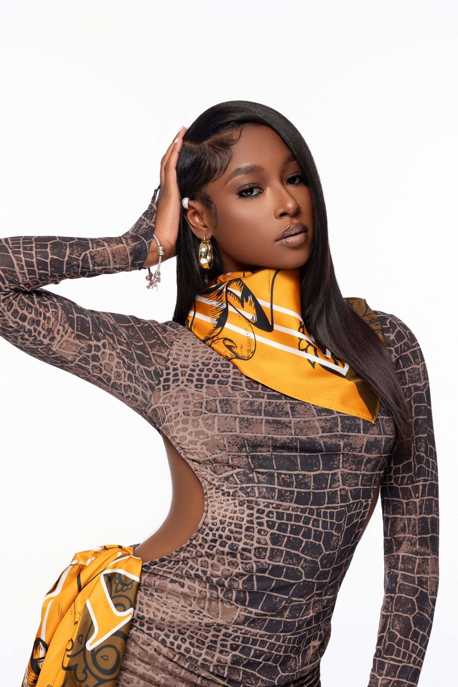 Fashion portrait featuring snakeskin pattern dress with yellow accents.