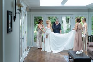 Bright indoor wedding venue with white walls and natural light streaming through windows.
