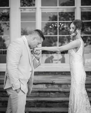 A black and white photo series captures a couple dancing playfully outdoors.