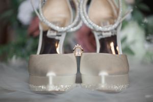 Elegant bridal shoes with crystal embellishments displayed against a soft background.